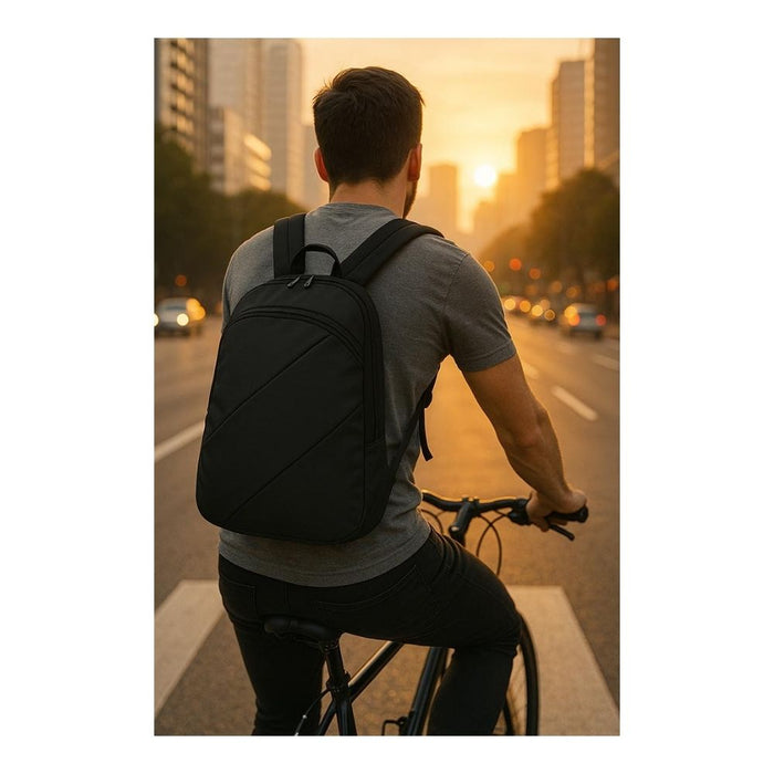 commuter wearing custom branded corporate company black laptop backpack while cycling in city at sunset, landscape