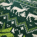 Close-up of green and white jacquard knit on a Christmas jumper
