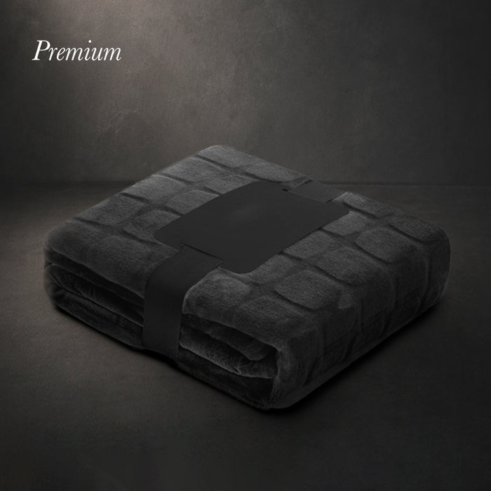 Black coral fleece blanket folded with a ribbon and gift card