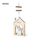 Wooden house-shaped hanging decoration with a cut-out festive scene