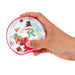 Handheld red water ring game with a Christmas scene inside
