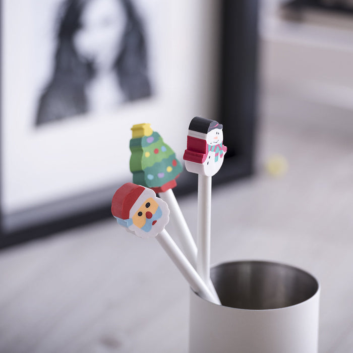 White pencils with Santa, tree and snowman eraser toppers in a pot
