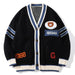 Branded black varsity-style cardigan with white V-neck trim embroidered letter patches